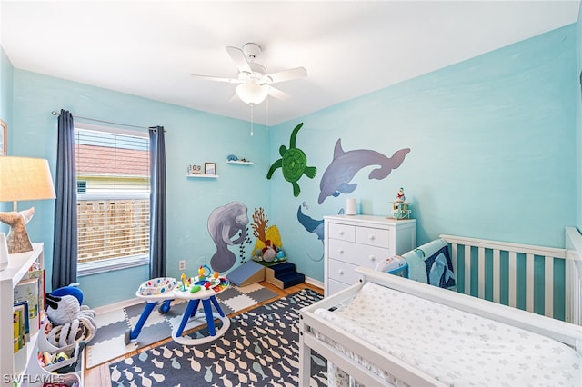 bedroom featuring hardwood / wood-style flooring and ceiling fan