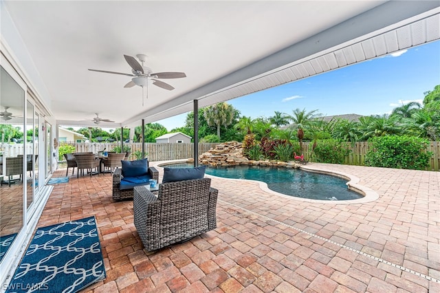 view of swimming pool with a patio area, outdoor lounge area, pool water feature, and ceiling fan