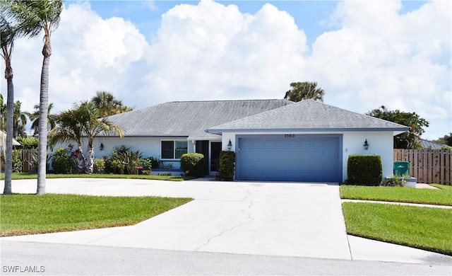 single story home with a garage and a front lawn