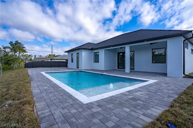 view of swimming pool featuring a patio area, pool water feature, and ceiling fan