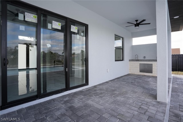 view of patio featuring ceiling fan