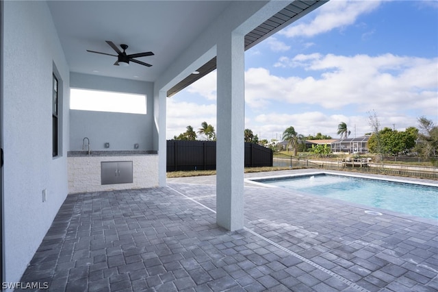 view of swimming pool with a patio area and ceiling fan