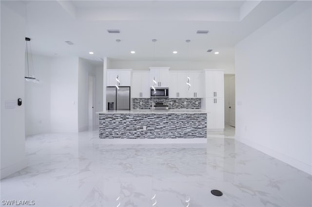 kitchen featuring white cabinets, stainless steel appliances, and pendant lighting