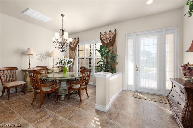 tiled dining space featuring a chandelier and plenty of natural light