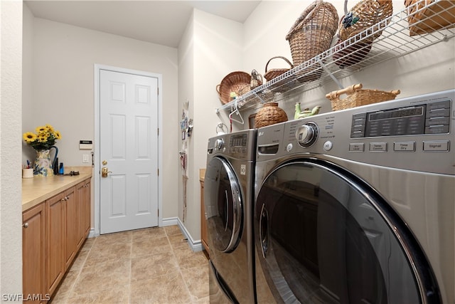 washroom with washer and clothes dryer and light tile patterned floors