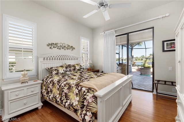 bedroom with wood-type flooring, access to exterior, and ceiling fan