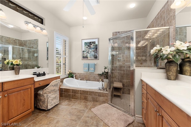 bathroom featuring shower with separate bathtub, vanity, and tile patterned flooring