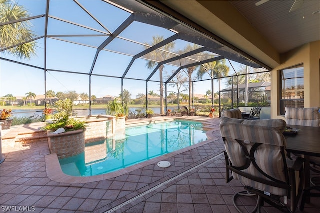 view of swimming pool featuring glass enclosure and a patio area