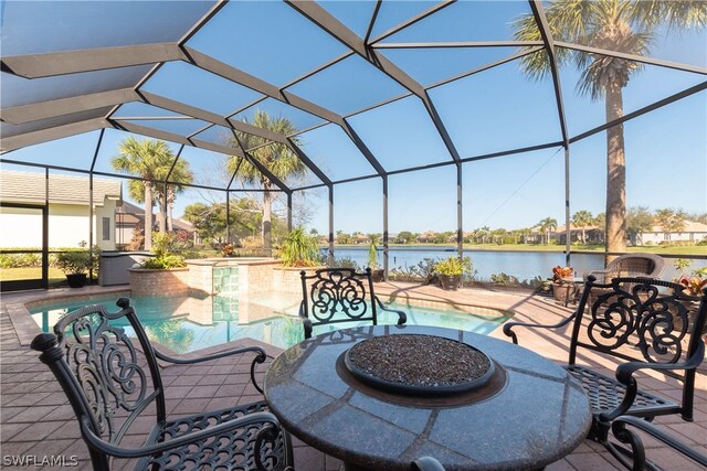 exterior space featuring a lanai, a water view, a patio area, and an outdoor fire pit