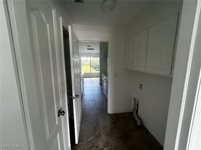 clothes washing area featuring cabinets and electric dryer hookup