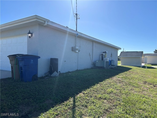 view of property exterior with cooling unit, a garage, and a yard