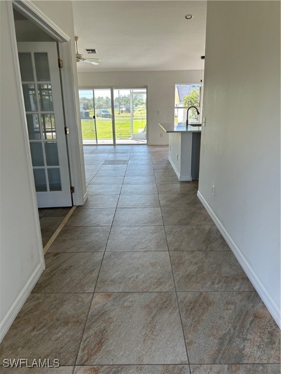 corridor featuring dark tile patterned floors