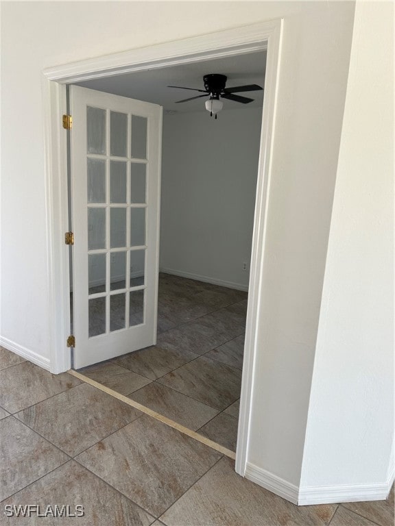 tiled empty room with ceiling fan