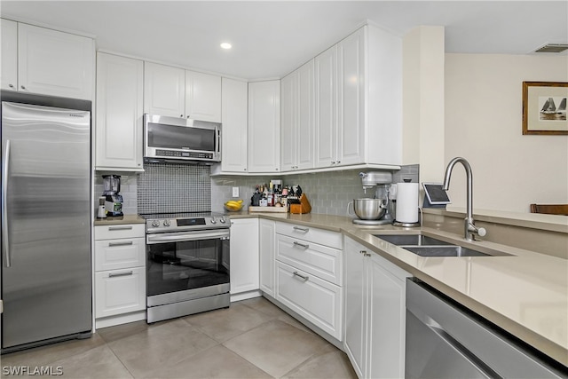 kitchen with white cabinetry, stainless steel appliances, and sink