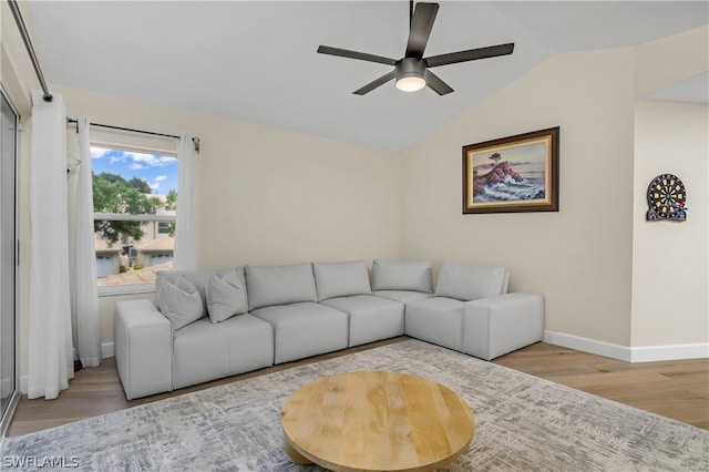 living room with ceiling fan, lofted ceiling, and light wood-type flooring