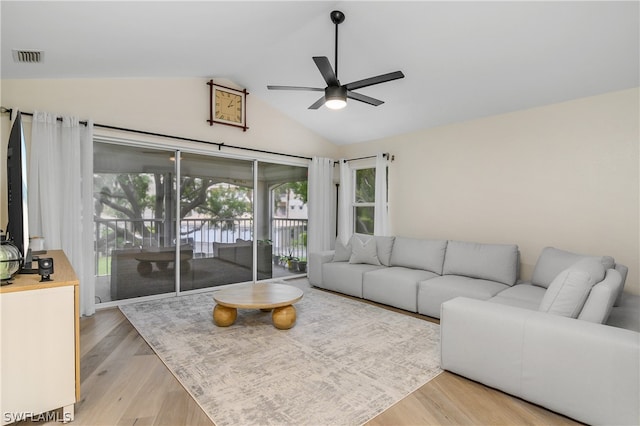 living room with vaulted ceiling, light hardwood / wood-style floors, and ceiling fan