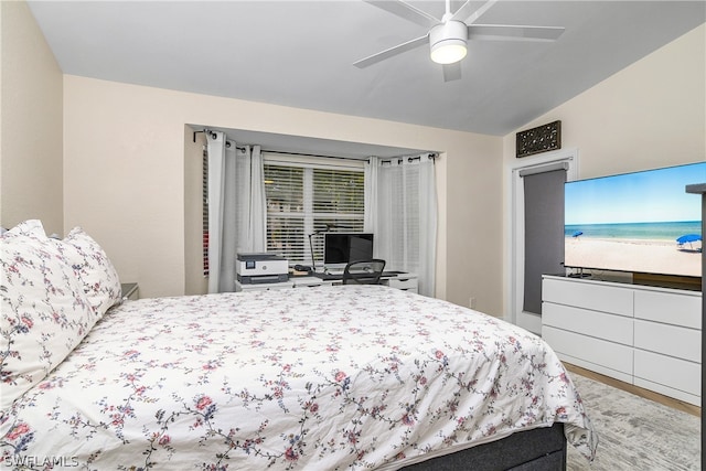 bedroom featuring lofted ceiling, light wood-type flooring, and ceiling fan