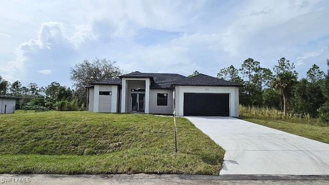 view of front of home featuring a front lawn and a garage