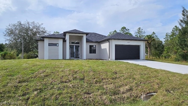 view of front of home with a front lawn and a garage