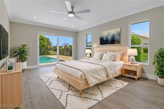 bedroom with access to exterior, ceiling fan, light hardwood / wood-style floors, and multiple windows