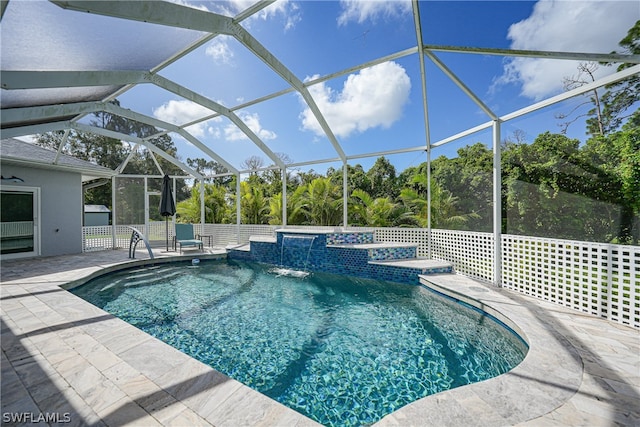 view of swimming pool featuring pool water feature, glass enclosure, and a patio