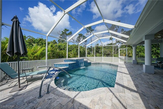 view of pool featuring pool water feature, a patio area, and a lanai