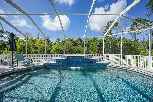 view of pool with pool water feature and a lanai