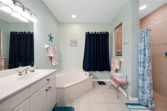 bathroom featuring tile patterned flooring, a bath, and vanity