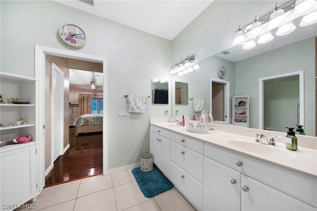 bathroom featuring tile patterned flooring and dual vanity