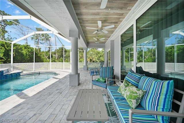 view of patio featuring ceiling fan, glass enclosure, fence, and an outdoor pool