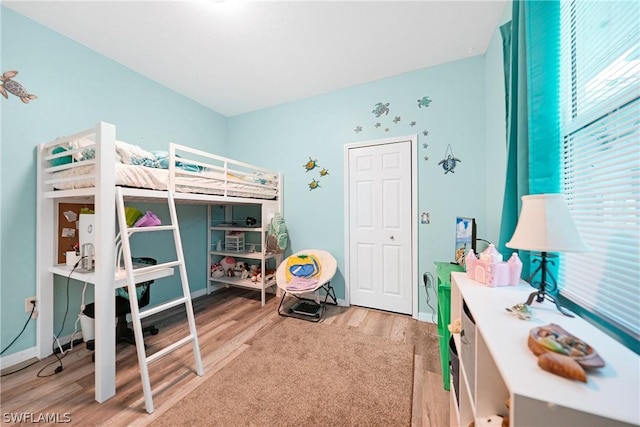 bedroom with baseboards and light wood-style floors