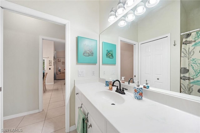 full bathroom featuring vanity, baseboards, a closet, and tile patterned floors