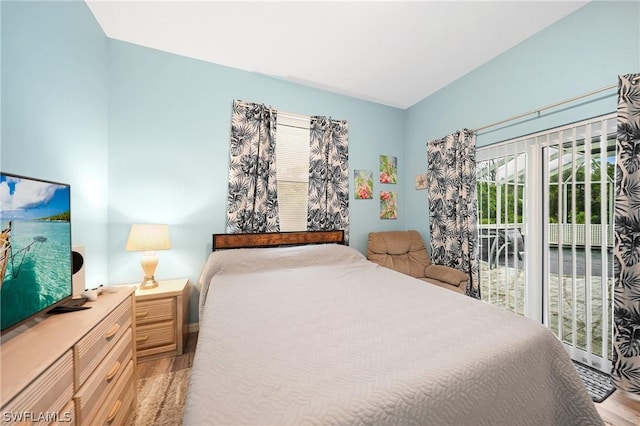 bedroom featuring light wood-style floors and access to exterior