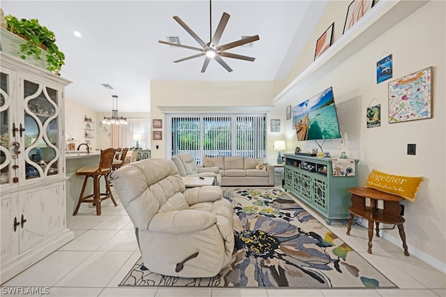 living room with light tile patterned flooring, ceiling fan with notable chandelier, and lofted ceiling