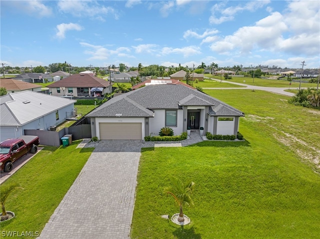 view of front of home featuring a garage and a front yard