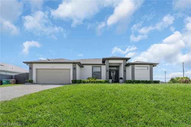 view of front of property featuring a garage and a front lawn