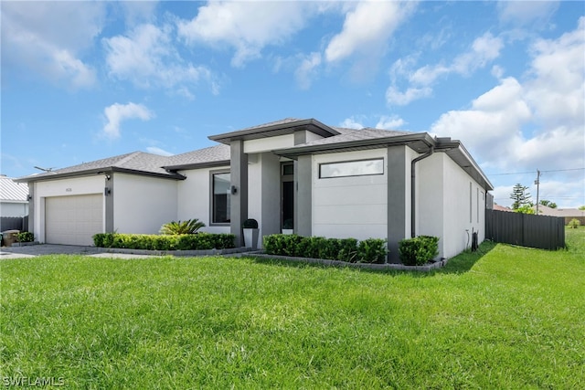 view of front of property featuring a garage and a front yard