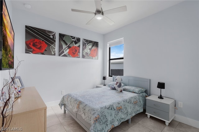 tiled bedroom featuring ceiling fan