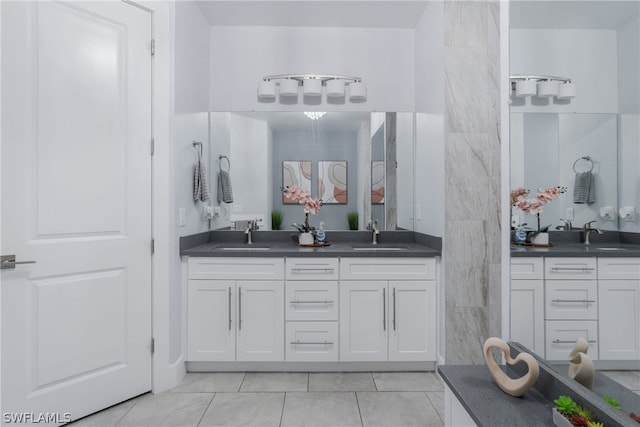 bathroom with tile patterned floors and dual bowl vanity