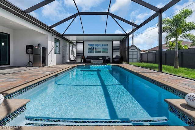 view of swimming pool featuring a storage shed, a lanai, and a patio