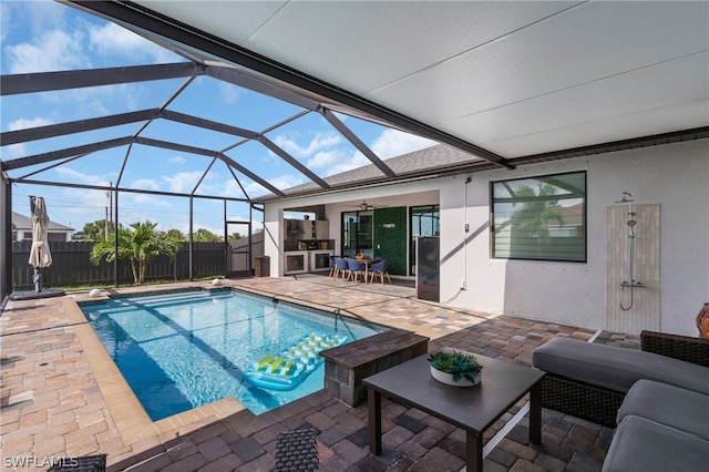 view of pool with a patio and a lanai