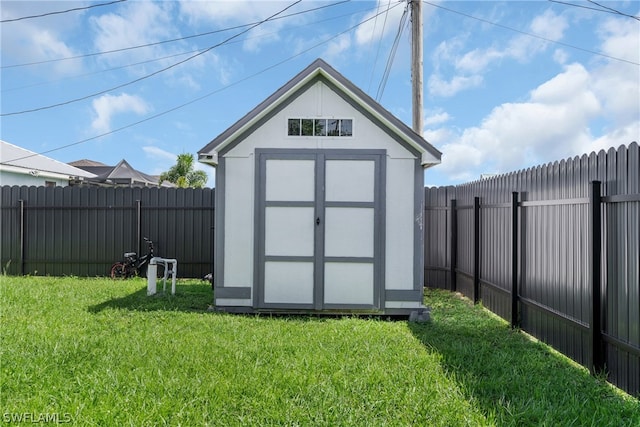 view of outbuilding featuring a lawn