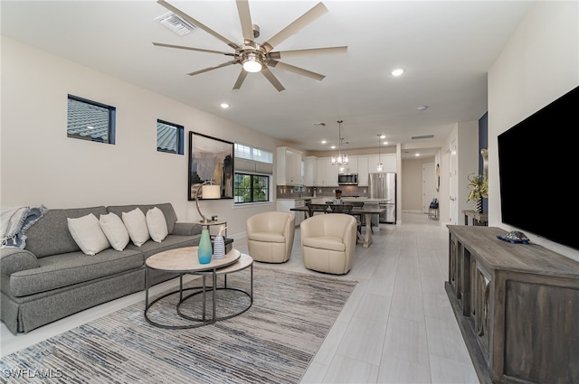 tiled living room with ceiling fan