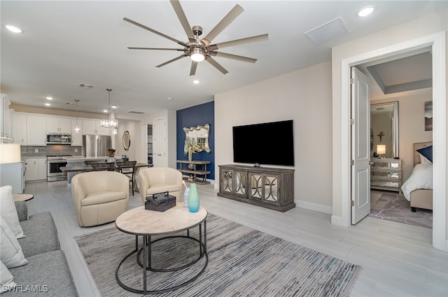 living room featuring light tile patterned floors and ceiling fan