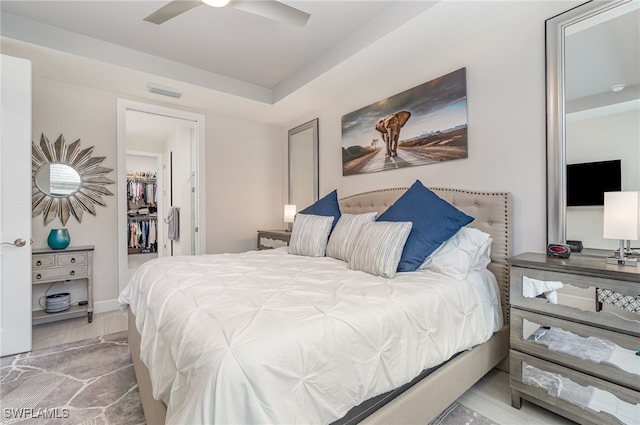 bedroom featuring a spacious closet and ceiling fan