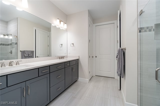 bathroom featuring a shower with shower door, tile patterned floors, and double sink vanity