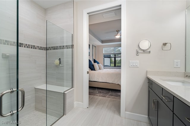 bathroom with tile patterned floors, an enclosed shower, vanity, and ceiling fan