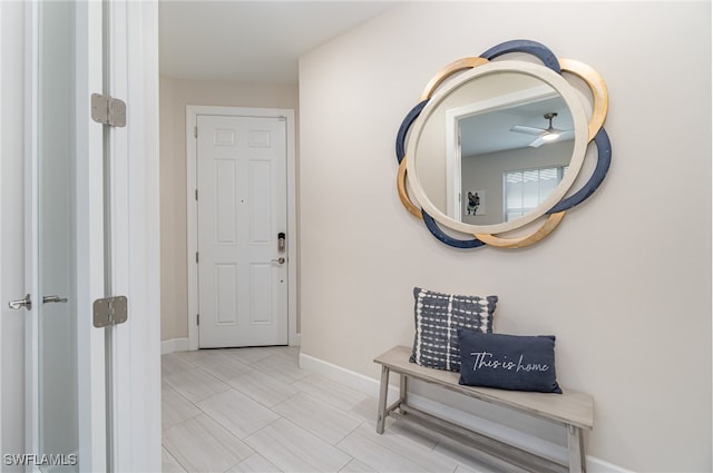 hall featuring light tile patterned floors