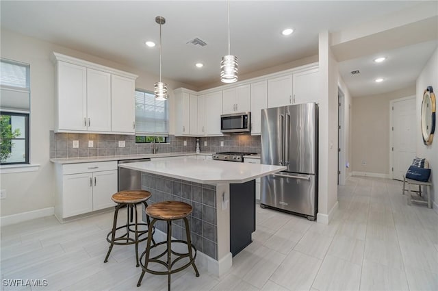 kitchen featuring a center island, white cabinets, and appliances with stainless steel finishes