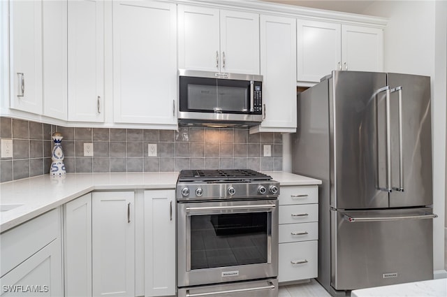 kitchen with appliances with stainless steel finishes, light stone countertops, tasteful backsplash, and white cabinets